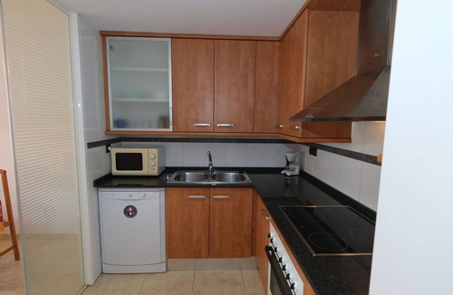 Sant Carles de la Rapita Apartment | Cosy apartment for 3 people with pool, A/C, TV and balcony