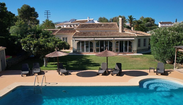 Charming Villa on one level with large pool, lawns, and tennis court in Javea